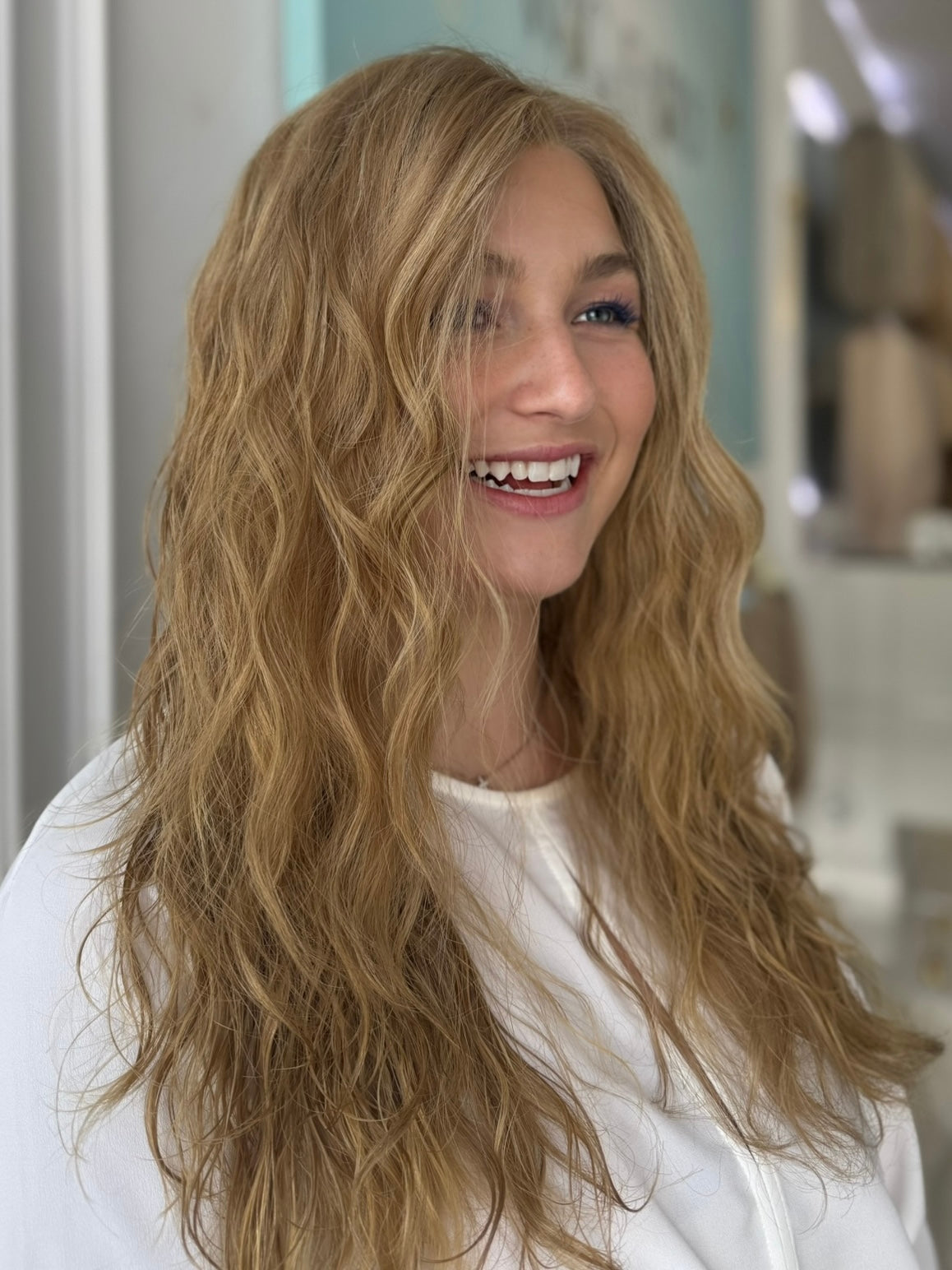 Model wearing Celine wavy wig in color a rich light brown color, soft natural texture and golden tone.