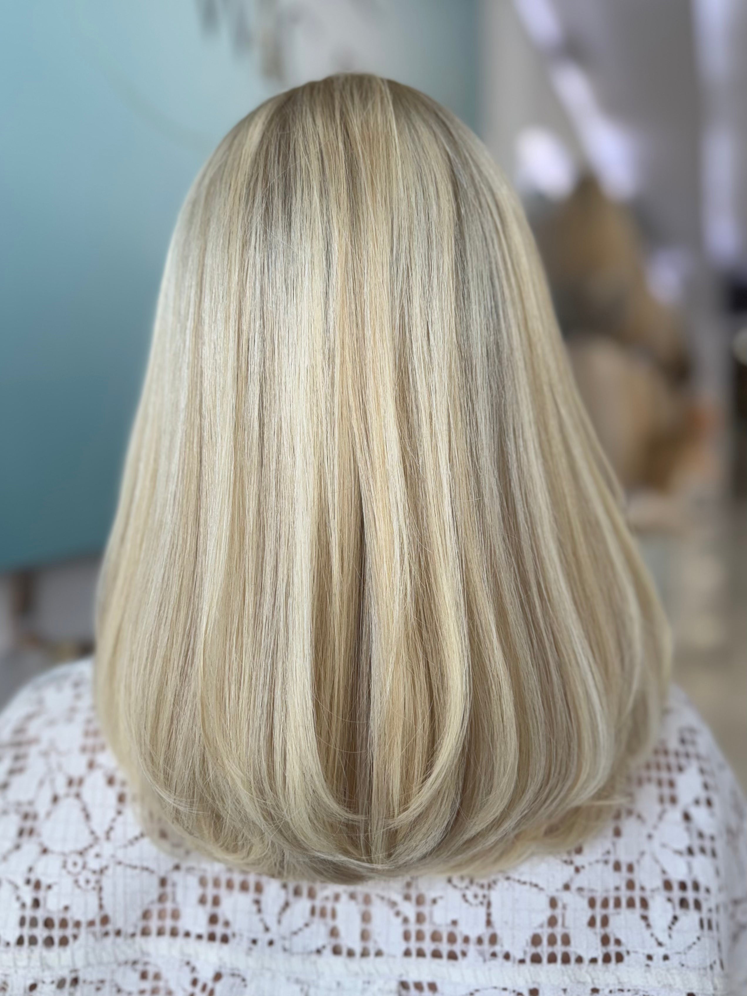 Clara 18-inch lace top wig in blonde with darker roots, featuring a sleek, smooth style and flawless lace for a natural, seamless finish.