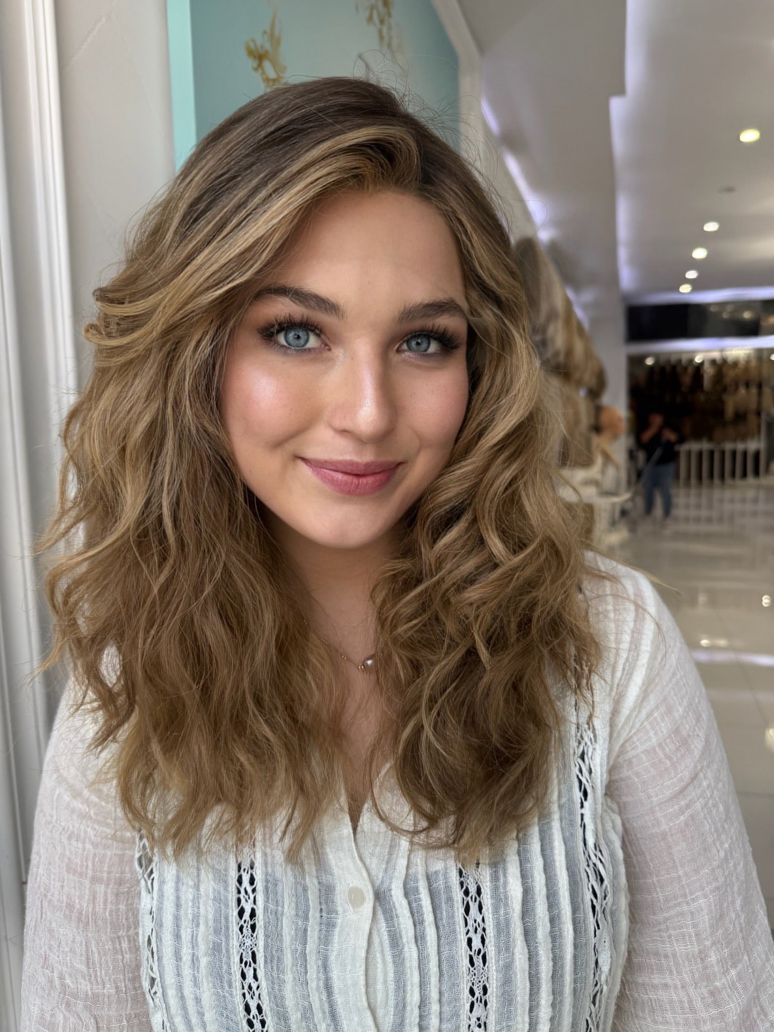 Dawn lace top wig, 22 inches in dirty blonde, styled in soft, flowing waves for a natural look with pre-cut lace for effortless wear.