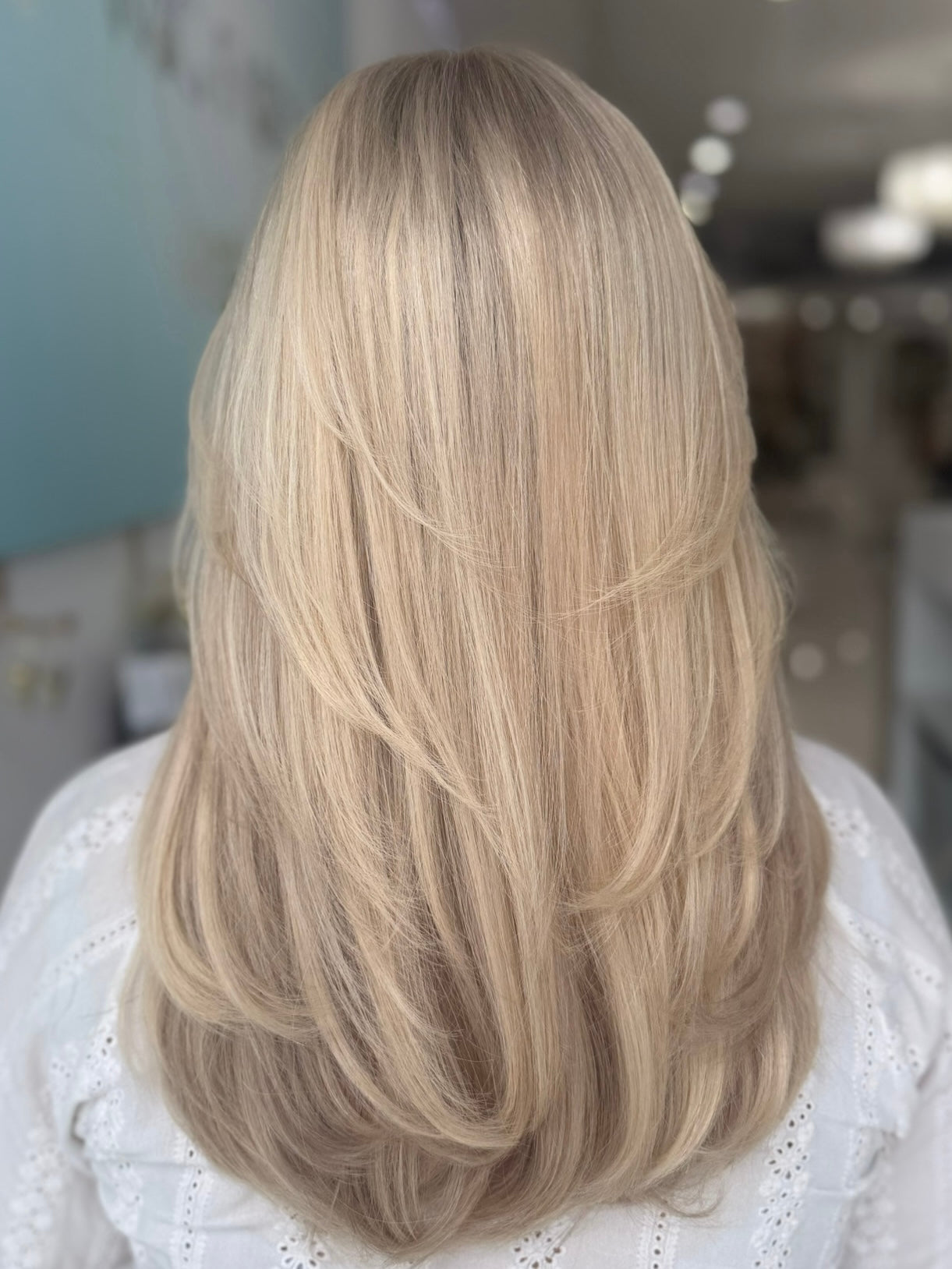 Eliza lace top wig, 23 inches in platinum blonde, with pre-cut lace for a flawless natural look, styled in elegant waves.