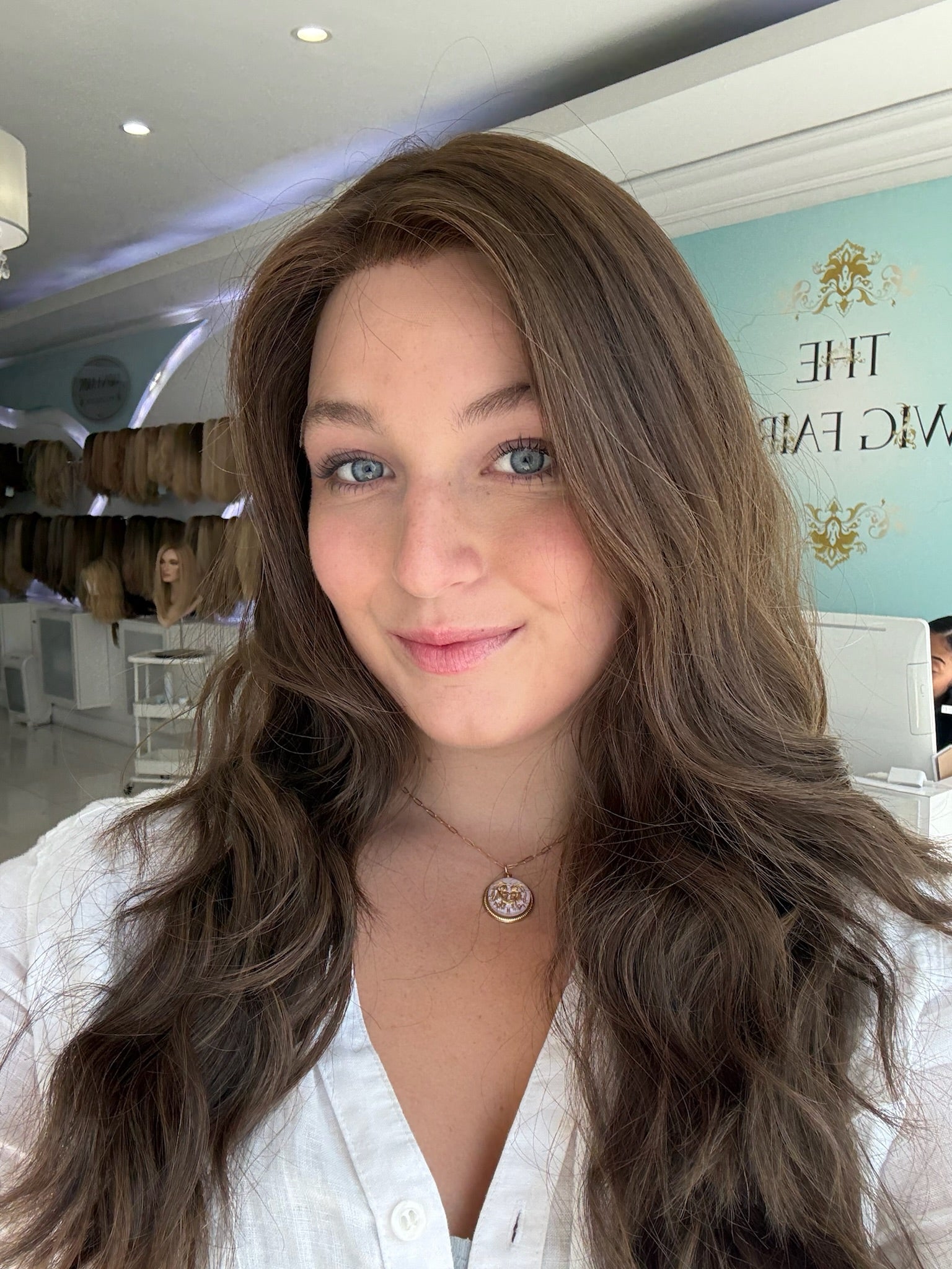 Close-up of brunette human hair wig with naturally wavy texture and skin top detail