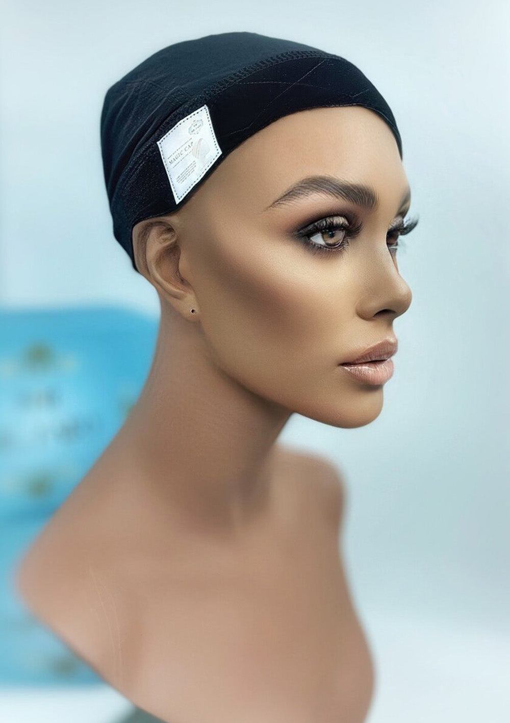Side view of Mona-Mor Magic Cap in black velvet on a mannequin, designed to keep wigs in place without clips or combs for sensitive scalps.
