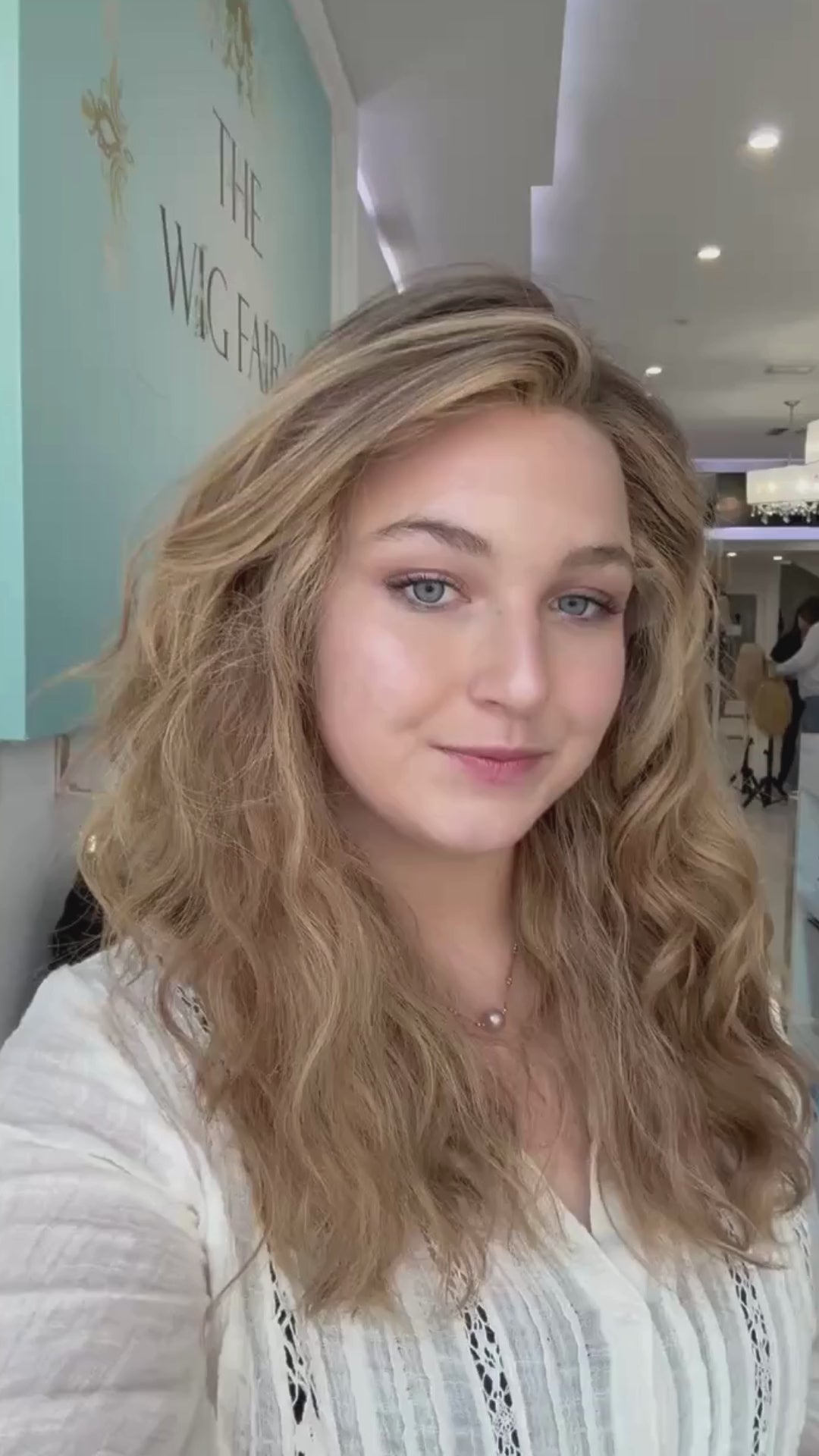 Medium-long wig in natural light brown with soft highlights, featuring subtle dimension and effortless flow.