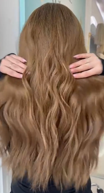 Video of the Erika wig featuring long brown hair with soft beach waves, showcasing natural movement and effortless texture.