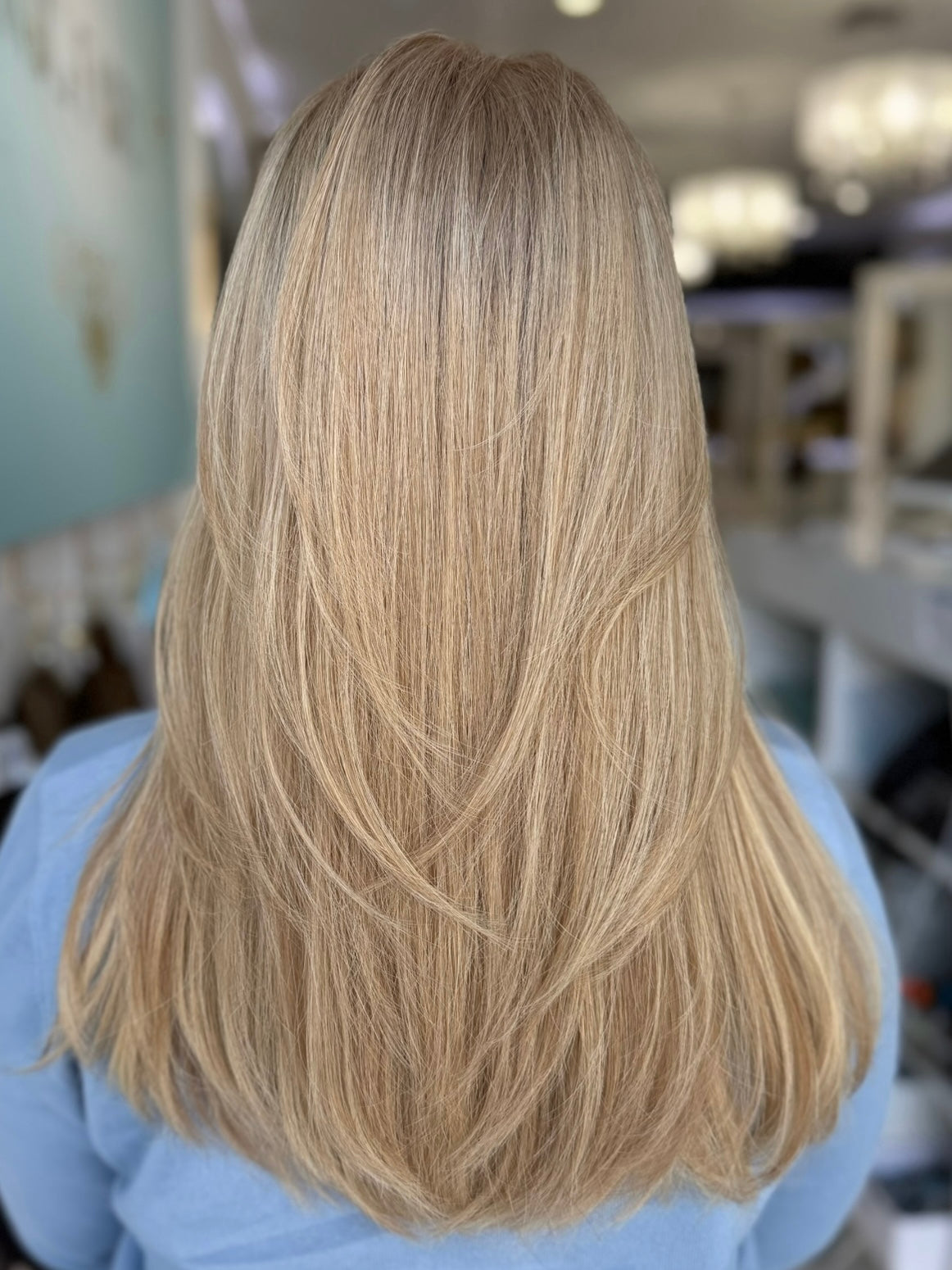 Back view of Charlotte wig showing sleek, 20-inch straight hair in a dimensional beige blonde shade.