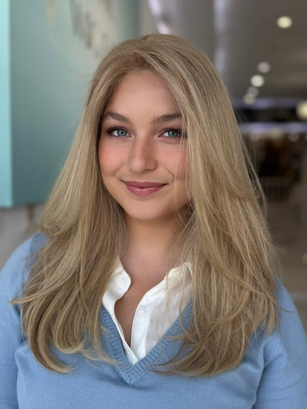Model wearing Charlotte 20-inch straight human hair wig in beige blonde, styled by Beverly Hills experts.