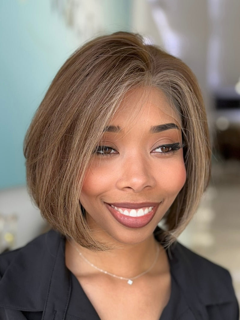 Meet Hazel! A chic 12-inch lace top wig featuring a medium brown base with subtle blonde highlights for a sophisticated and natural look. Expert styling included.