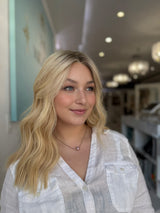 Front view of model wearing 20-inch blonde lace top wig in color #C-2, styled in soft waves for a natural look.