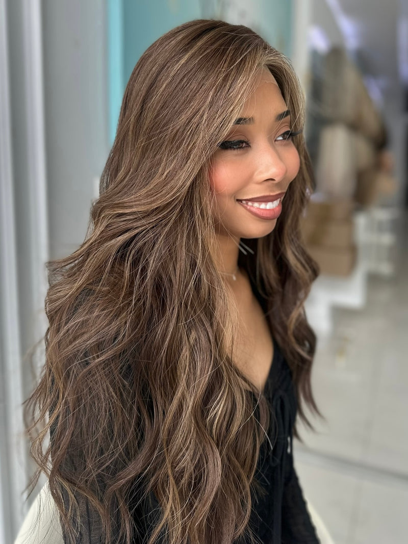 Angled view of Sasha human hair wig, highlighting soft texture and warm brown dimension.