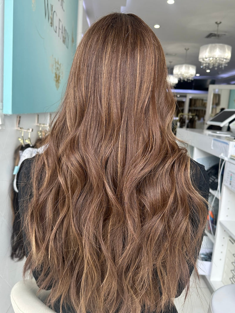Back view of Sasha wig, featuring long, flowing waves in rich espresso brown with natural highlights.