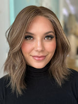 Front view of Camila luxury wig with natural waves, lace front, and a rich blend of chocolate, ash, and sandy tones