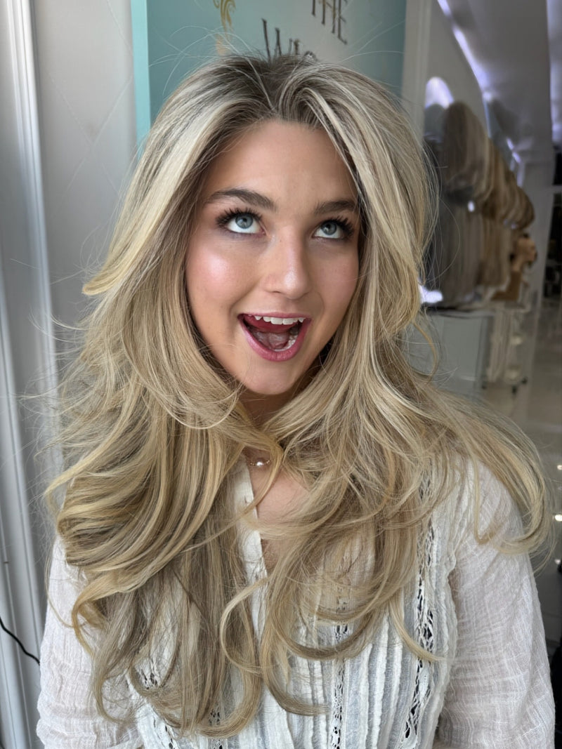  Candice lace top wig, 26 inches in blonde, with pre-cut lace for a flawless, natural look, styled in glamorous, voluminous waves.