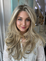 Candice lace top wig, 26 inches in blonde, styled in voluminous waves for a bombshell look with pre-cut lace for a flawless, natural appearance.