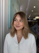 Carmen lace top wig in brunette root with soft ombré blonde highlights, side view