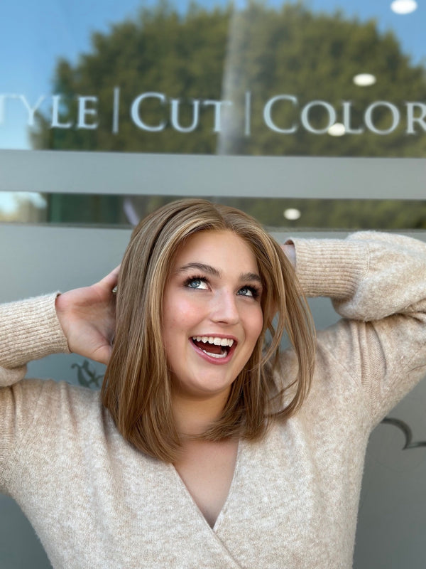Carrie lace top wig, 18 inches in blonde, styled in a chic bob with soft layers for a fun, flirty look with pre-cut lace for flawless wear.