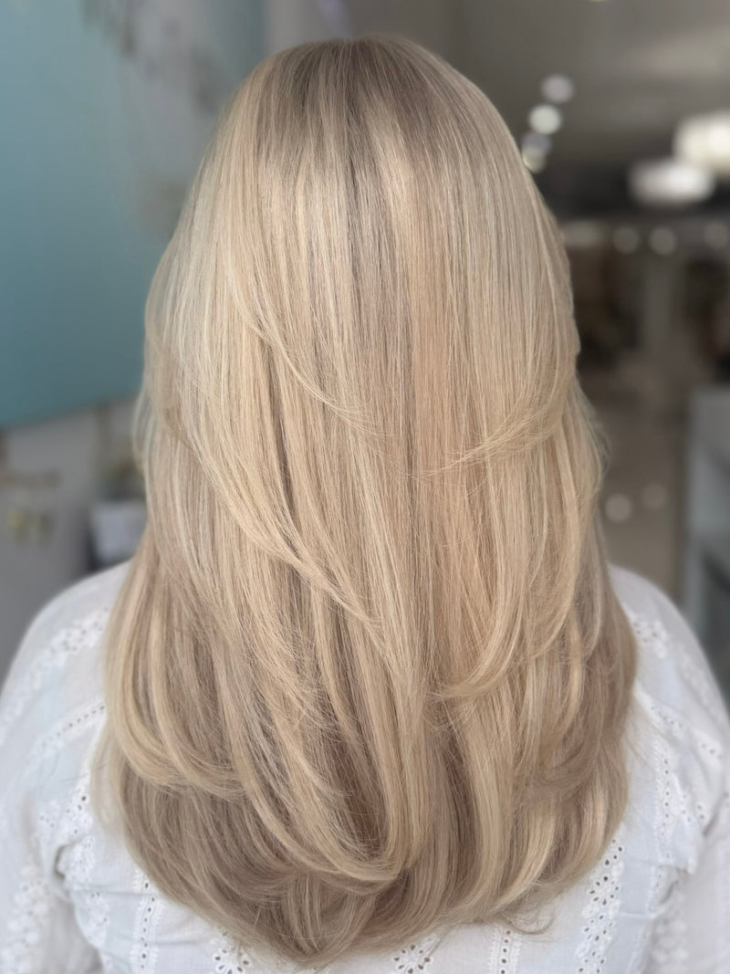 Eliza lace top wig, 23 inches in platinum blonde, with pre-cut lace for a flawless natural look, styled in elegant waves.