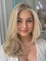 Eliza lace top wig, 23 inches in platinum blonde, styled in soft waves for a flawless, natural look with pre-cut lace for easy wear.