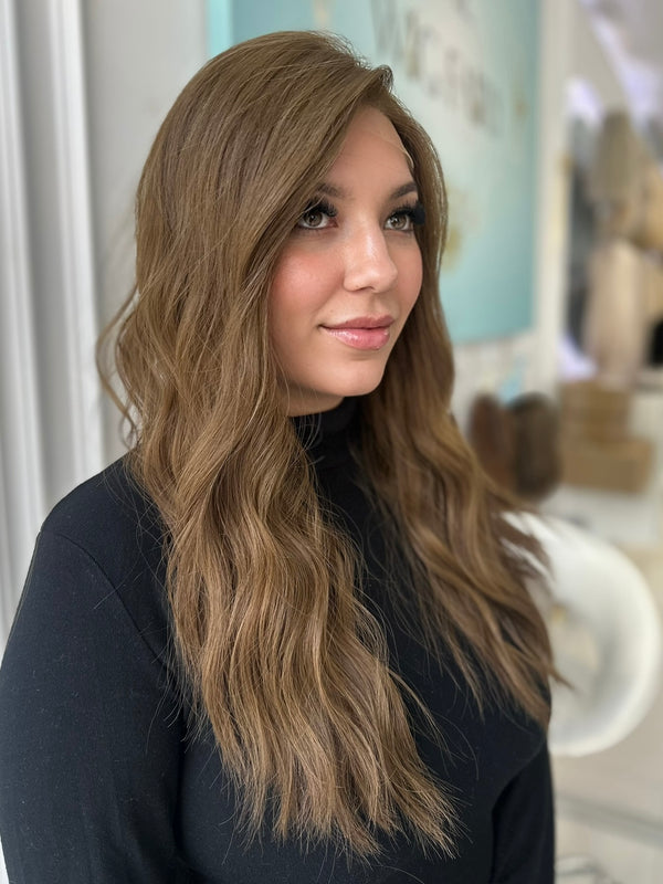 Angled view of Erika wig, 26-inch length with Lace Top, styled in loose waves and natural ash brown color