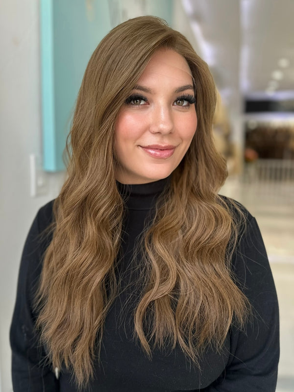 Front view of Erika wig in medium ash brown, pre-cut lace top and soft wavy style, 26-inch length