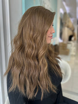 Side view of Erika luxury wig in medium ash brown with soft beachy waves, 20 inches with Lace Top