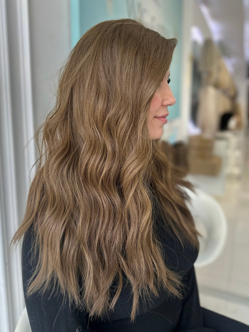 Side view of Erika luxury wig in medium ash brown with soft beachy waves, 20 inches with Lace Top