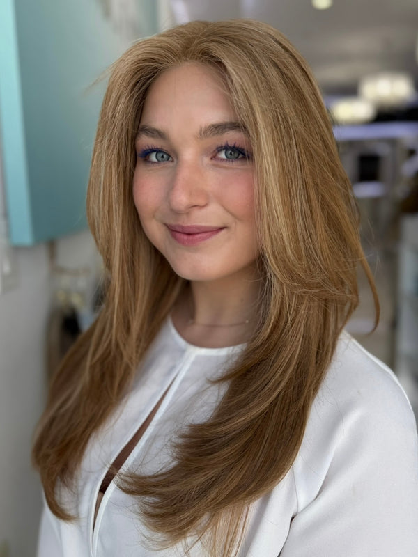 Front angled view of a model wearing the Georgia wig – brunette blend in #8/14, styled in soft layers.