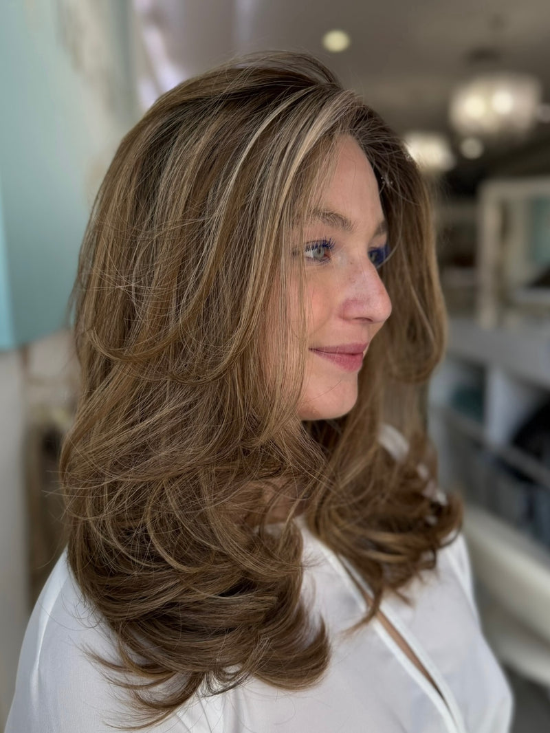 Side view of the Georgia wig displaying natural flowing layers in rich brown with caramel tones, 20 inches long, designed with pre-cut lace for effortless wear
