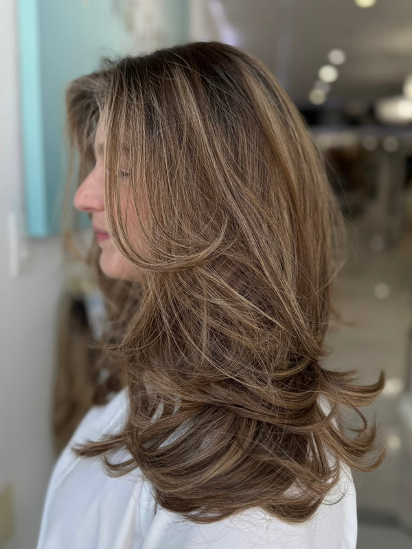 Side profile of the Georgia wig showcasing layered waves in medium brown with subtle caramel highlights, 20 inches, with pre-cut lace for a seamless blend.