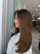 European lace top wig with flowing layers and left part, side view