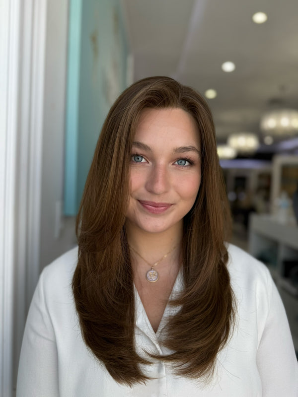 Long ombré human hair wig with layers and left-side parting in a natural light brunette tone