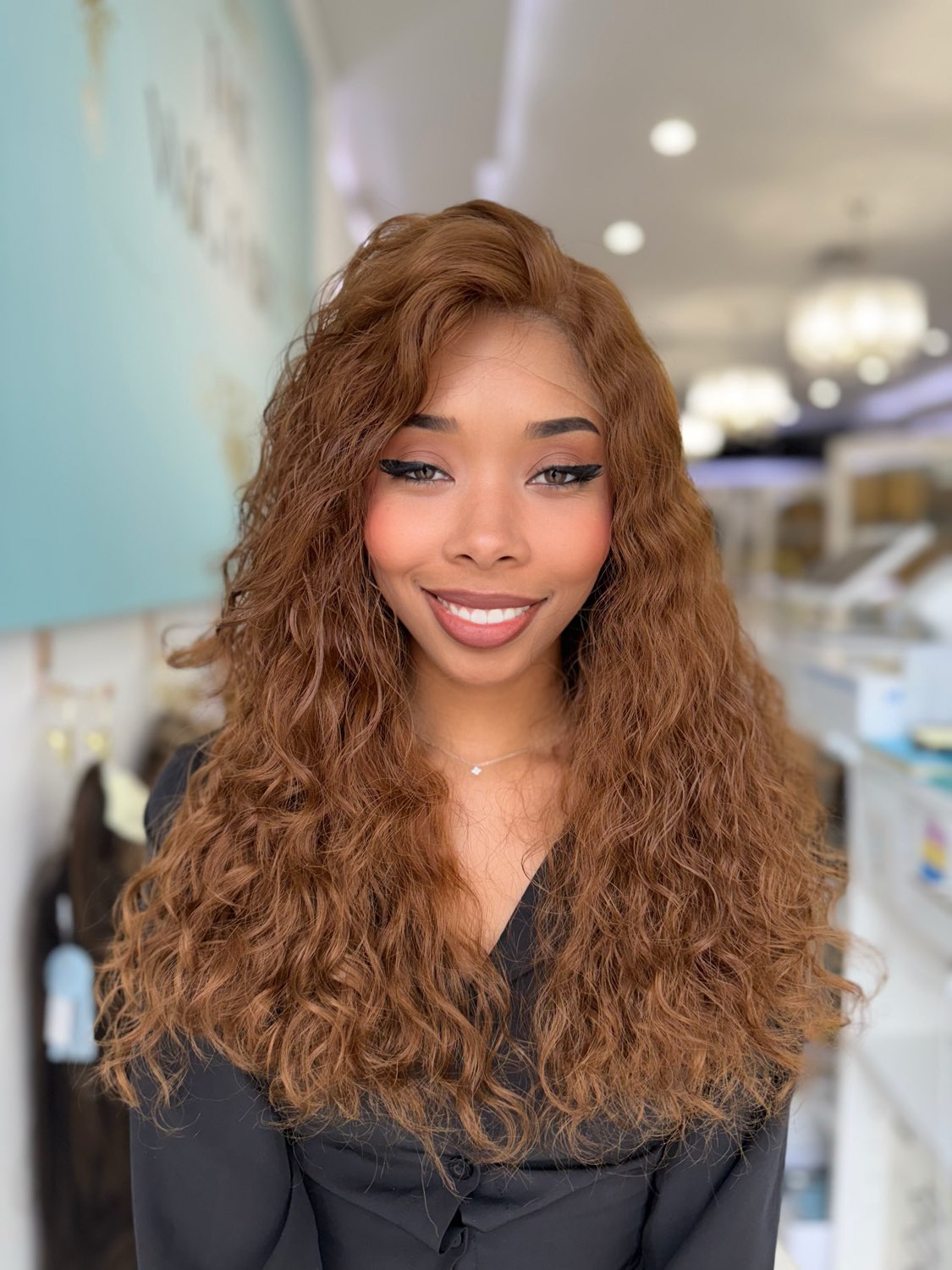 Ginger: A luxurious 24-inch curly lace top human hair wig in a beautiful light copper tone. Available in 16, 18, and 22 inches. Our stylists will contact you to customize the perfect fit and style.