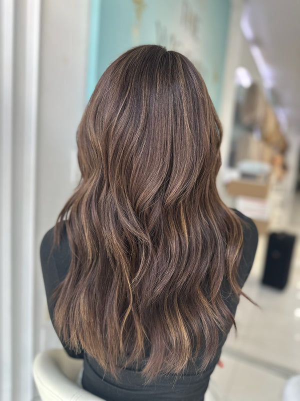 Jada lace top wig, 22 inches in brown with caramel highlights, with pre-cut lace for a flawless, natural look, styled in elegant waves.