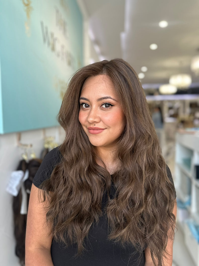 Skin top wig with seamless part and soft waves in a dark brown blend