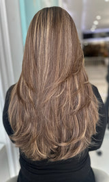 Luxury wig Gracie 22 inches in warm chestnut brown with golden blonde highlights, shown from the back with soft layers