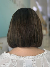 Noelle lace top wig, 16 inches in dark brown with highlights, with pre-cut lace for a flawless natural look, styled in a stylish bob cut.