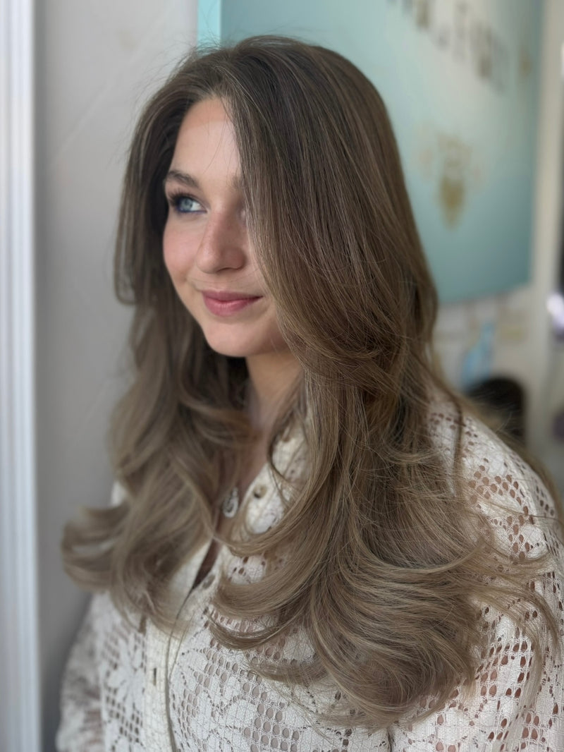 Nora 22-inch lace top wig in light brown blonde, featuring voluminous waves and flawless lace for a seamless, natural finish.