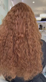 Video of a long, naturally curly red wig, highlighting its vibrant color, defined curls, and realistic movement.
