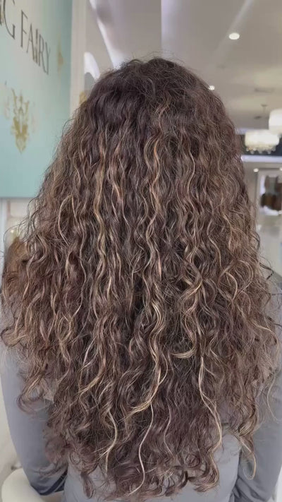 Video of a long, naturally curly brown wig, showcasing defined curls, rich color, and realistic movement.