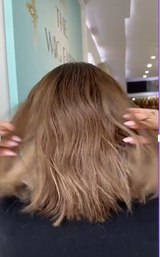 Video of a short, wavy human hair wig in rich brown with caramel highlights, showing soft movement and natural texture.