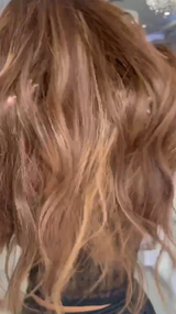 Long brown wavy luxury wig with soft, flowing texture and natural shine, showcasing high-end craftsmanship and realistic movement.