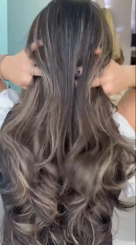 Long, luscious brown wig with rich waves and blonde highlights, offering full-bodied texture and natural movement.