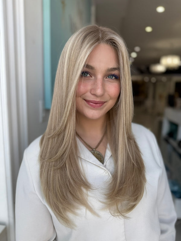 Roxanne lace wig with face-framing layers and smooth texture in warm blonde tones