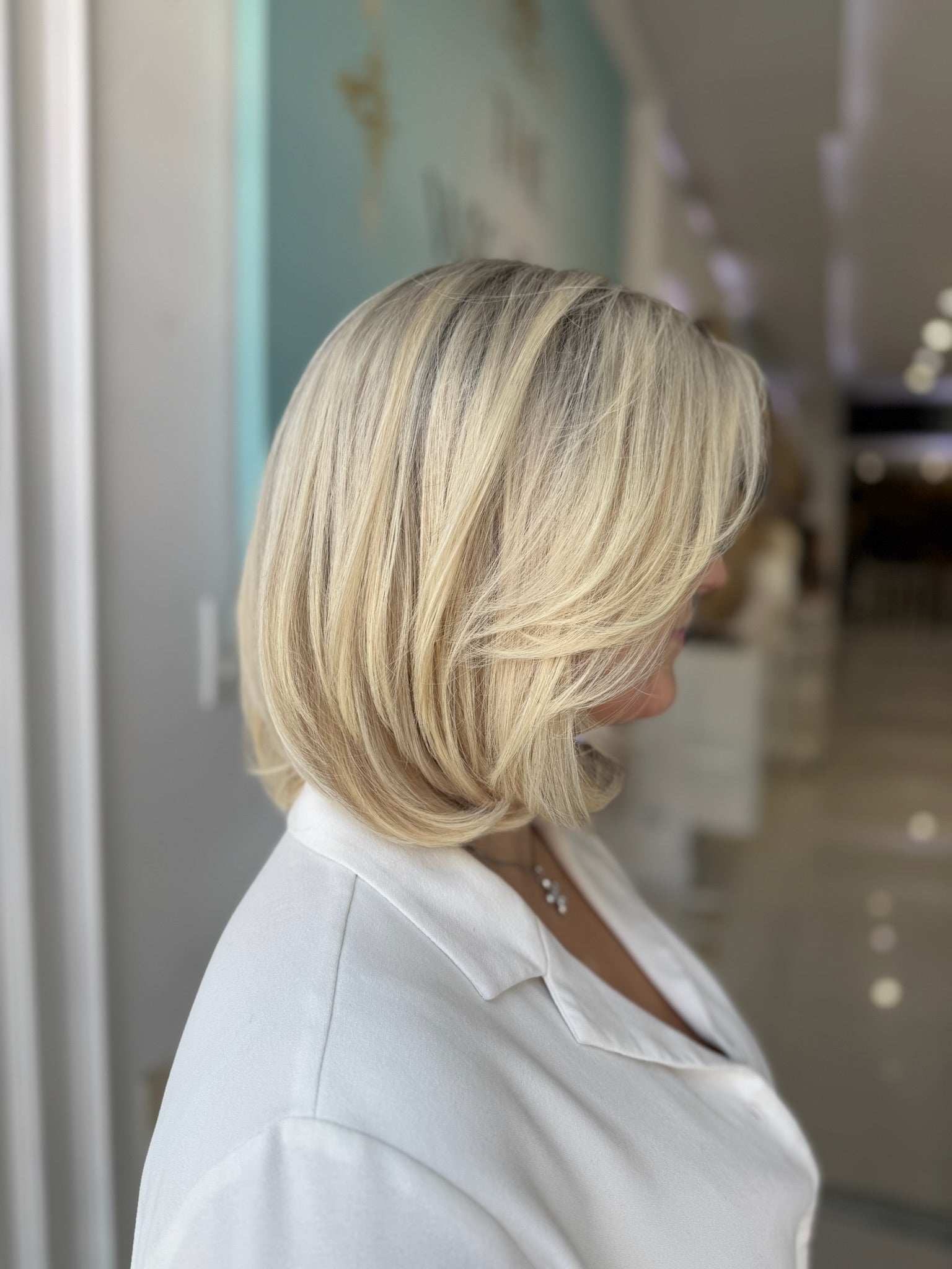 Side profile of Samantha lace top wig in blonde, 16 inches