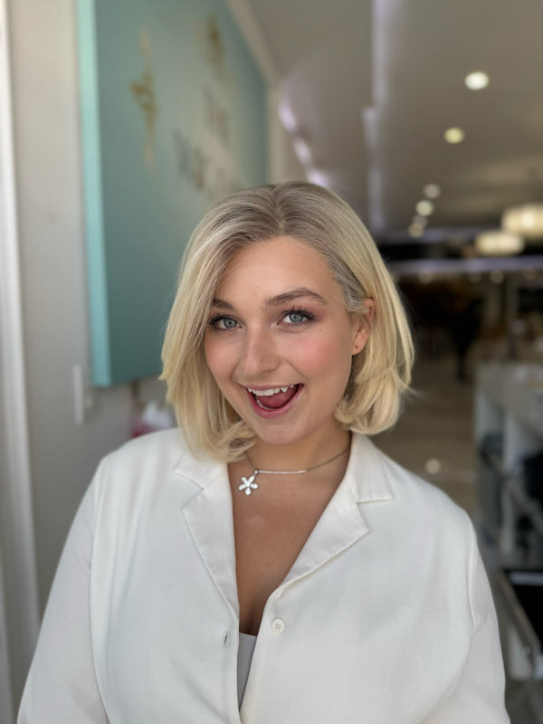 Model wearing 16-inch short blonde European lace top wig — front view