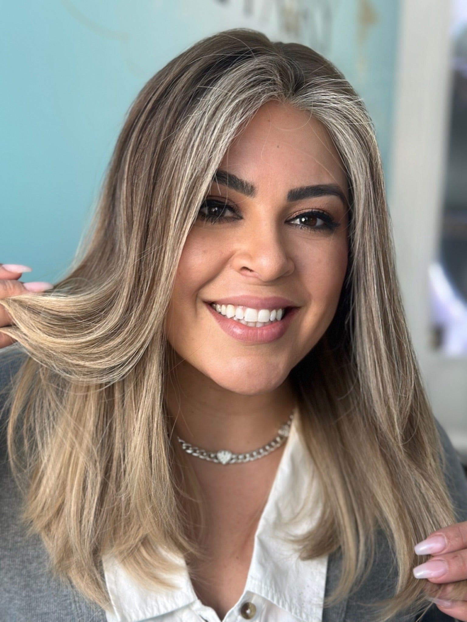 Trisha lace top wig, 22 inches in brown with light money pieces, styled with soft layers and pre-cut lace for a flawless, fresh look.