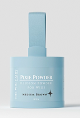 Wig Fairy Powder in medium brown, housed in a baby blue box. Ideal for creating a fuller, natural look by covering bald spots or matching scalp tone to skin tone.