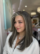 Model wearing Zora 20-inch long silver gray lace front wig