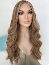 Frontal angled view of Aliana wig from The Wig Fairy, made with 100% Brazilian hair and styled in cool beige blonde tones with a natural lace front.