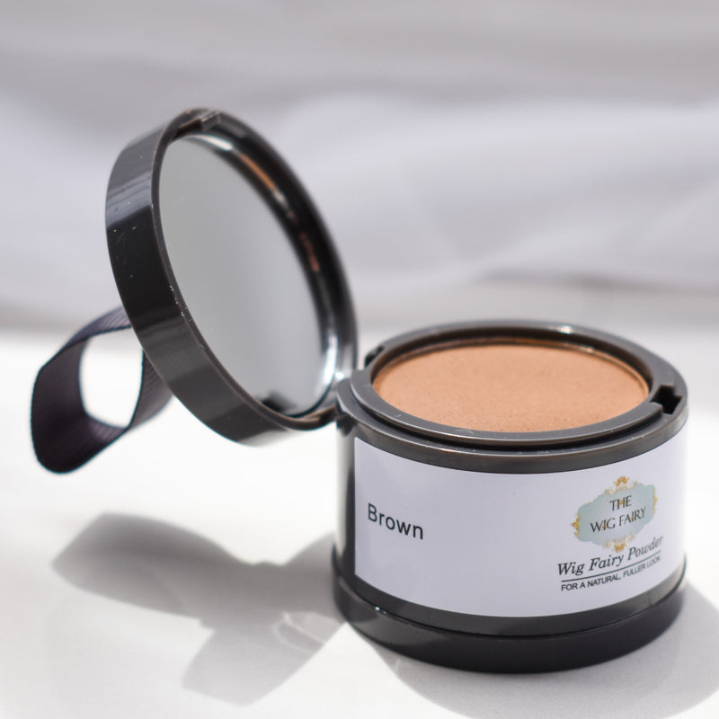 Open Wig Fairy Powder container in dark brown, showing the powder inside for natural scalp blending